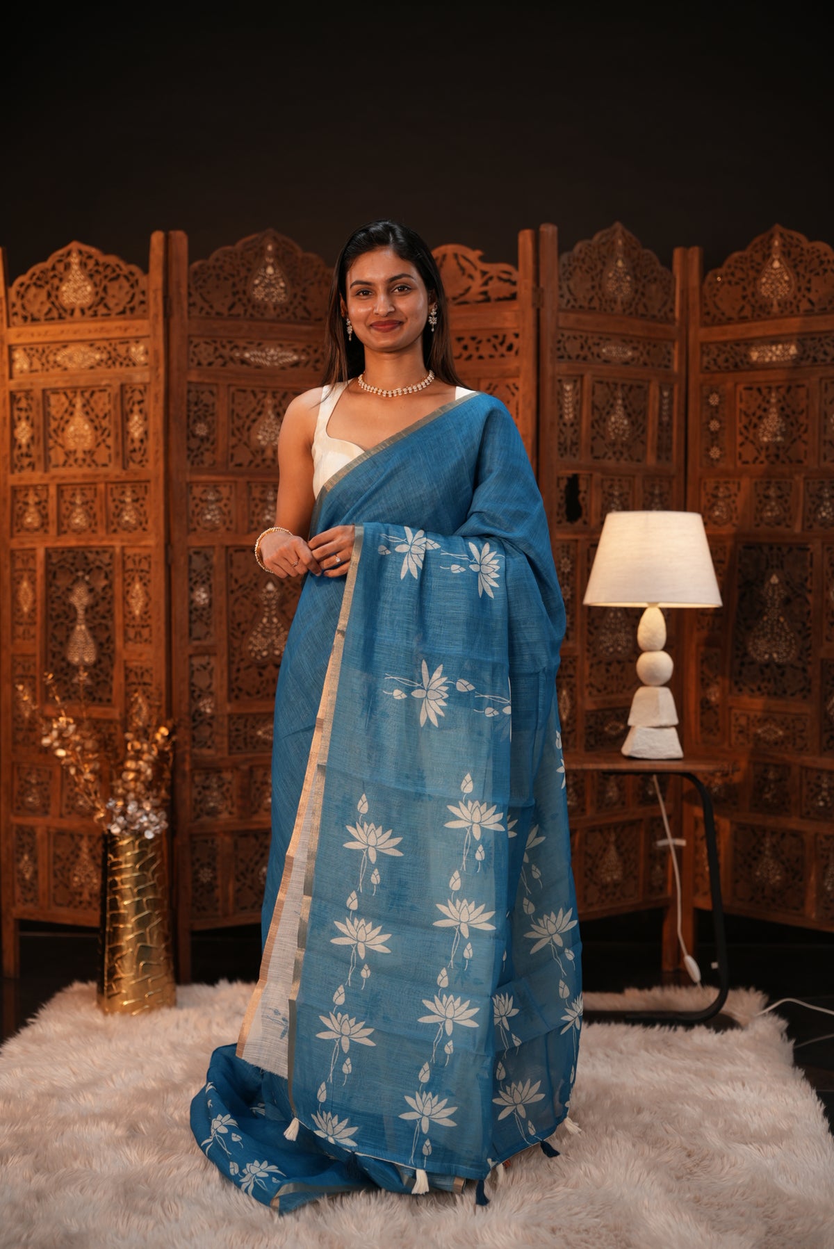 Sky Blue colour Semi Linen saree featuring plain & lotus print, Bavanchi border & same print on Pallu, comes with contrast colour blouse piece.