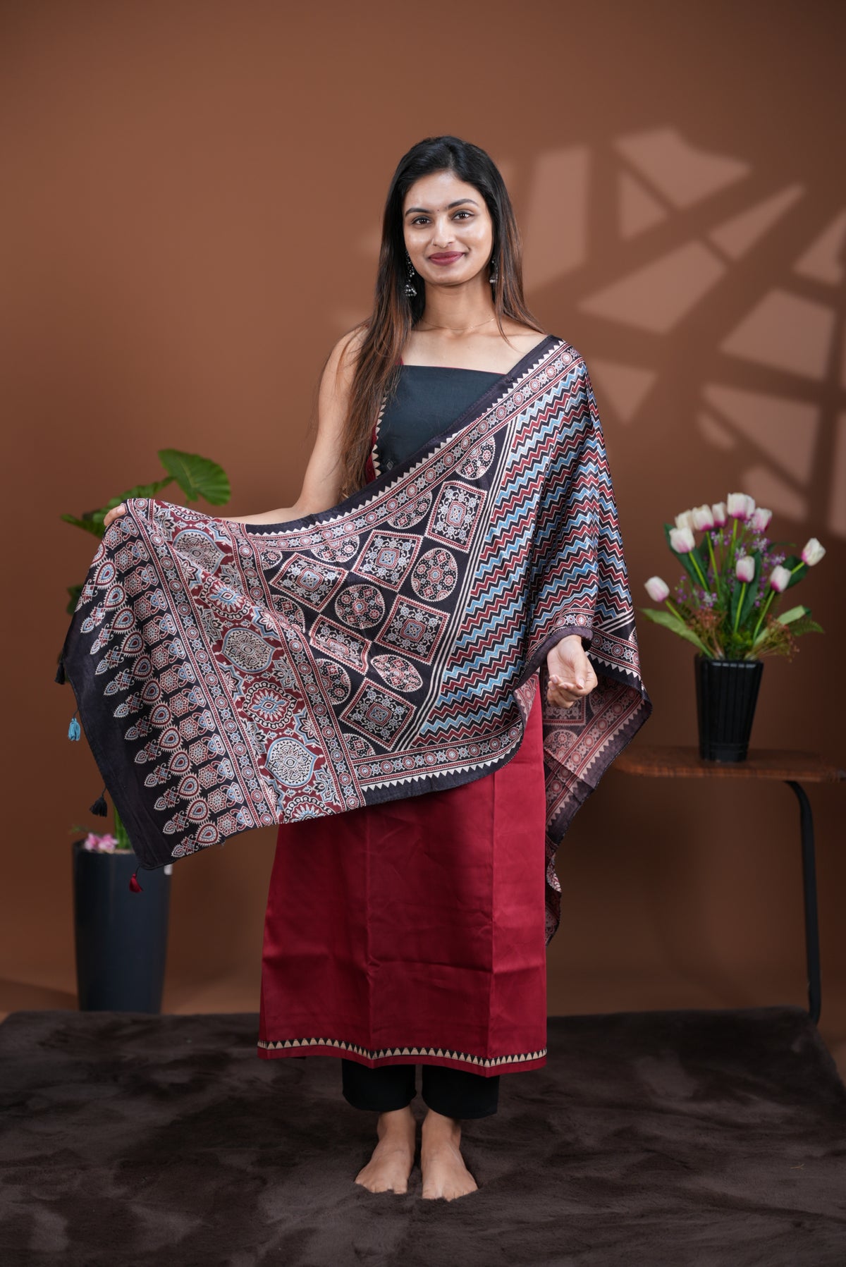 Maroon colour Jam Satin salwar material, Plain body with mirror & thread work on neck portion, matching bottom and Dupatta with ajrak print.