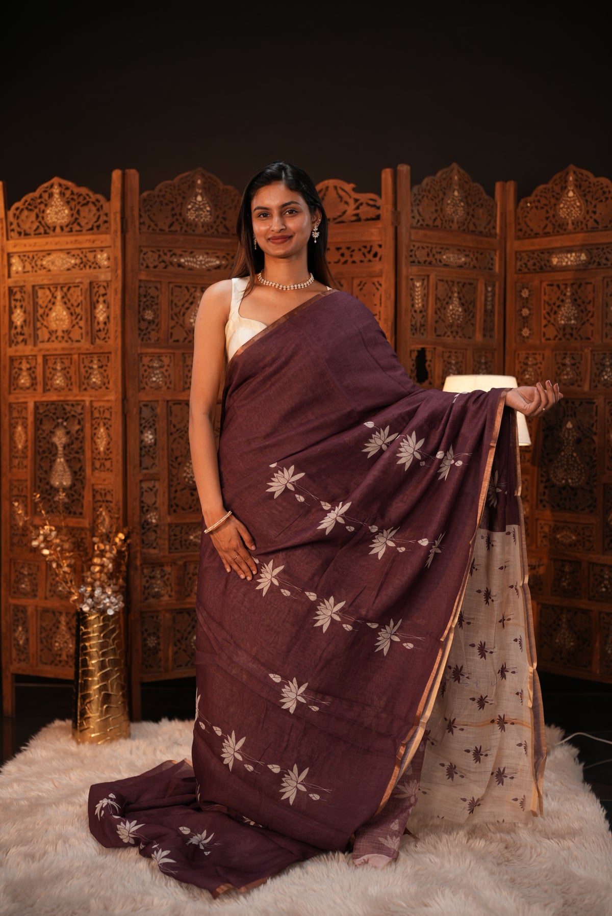 Wine colour Semi Linen saree featuring plain & lotus print, Bavanchi border & same print on Pallu, comes with contrast colour blouse piece.