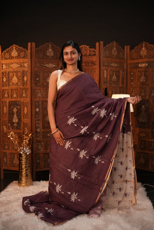 Wine colour Semi Linen saree featuring plain & lotus print, Bavanchi border & same print on Pallu, comes with contrast colour blouse piece.