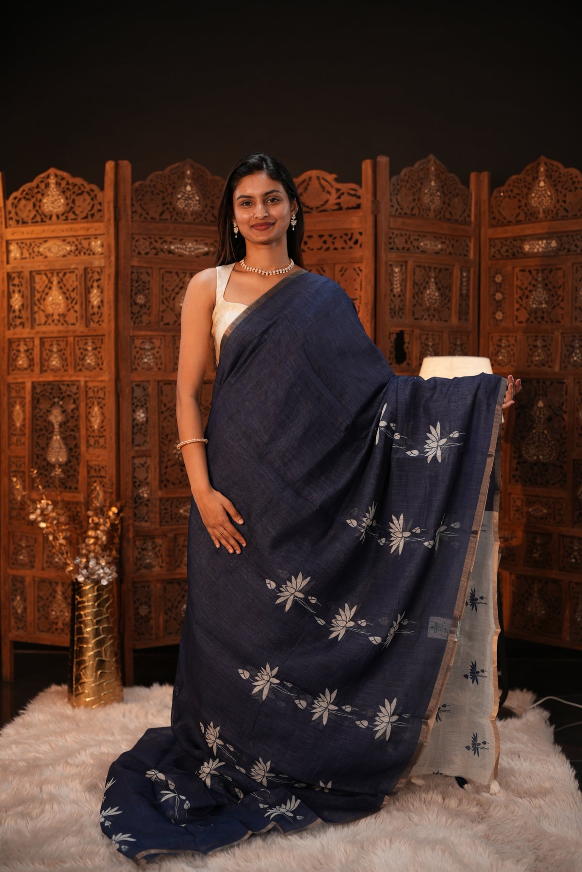 Indigo colour Semi Linen saree featuring plain & lotus print, Bavanchi border & same print on Pallu, comes with contrast colour blouse piece.