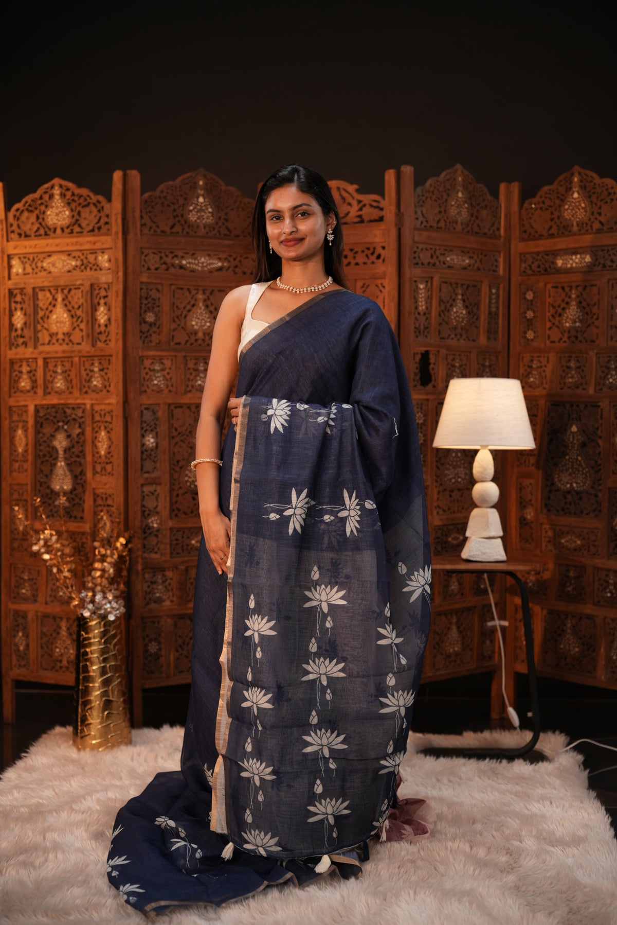 Indigo colour Semi Linen saree featuring plain & lotus print, Bavanchi border & same print on Pallu, comes with contrast colour blouse piece.