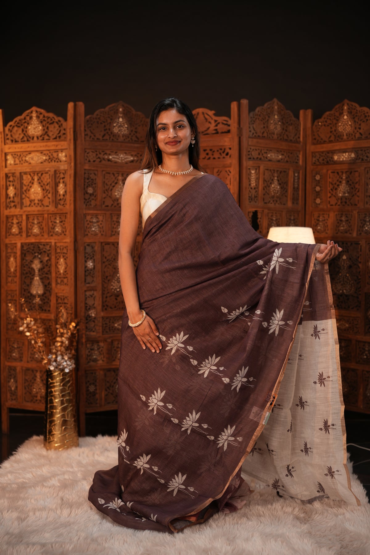 Mocha colour Semi Linen saree featuring plain & lotus print, Bavanchi border & same print on Pallu, comes with contrast colour blouse piece.