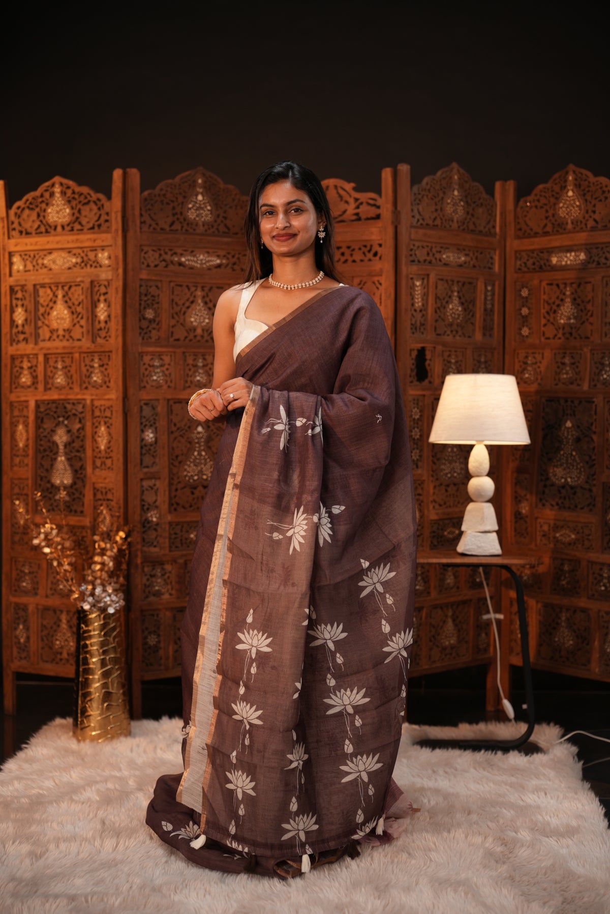 Mocha colour Semi Linen saree featuring plain & lotus print, Bavanchi border & same print on Pallu, comes with contrast colour blouse piece.