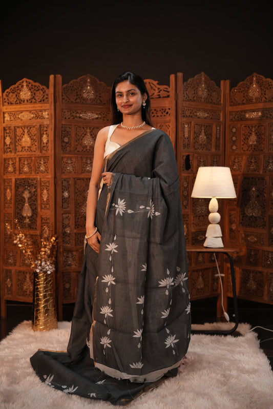Dark Green colour Semi Linen saree featuring plain & lotus print, Bavanchi border & same print on Pallu, comes with contrast colour blouse piece.