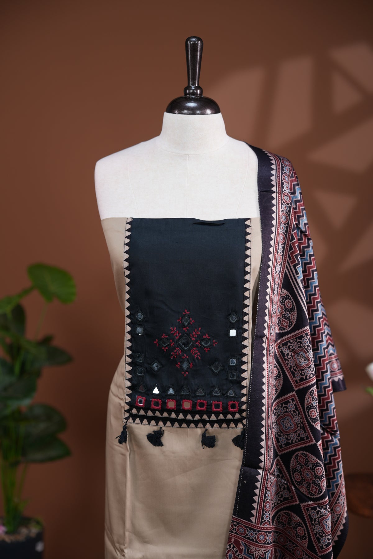 Cream colour Jam Satin salwar material, Plain body with mirror & thread work on neck portion, matching bottom and Dupatta with ajrak print.
