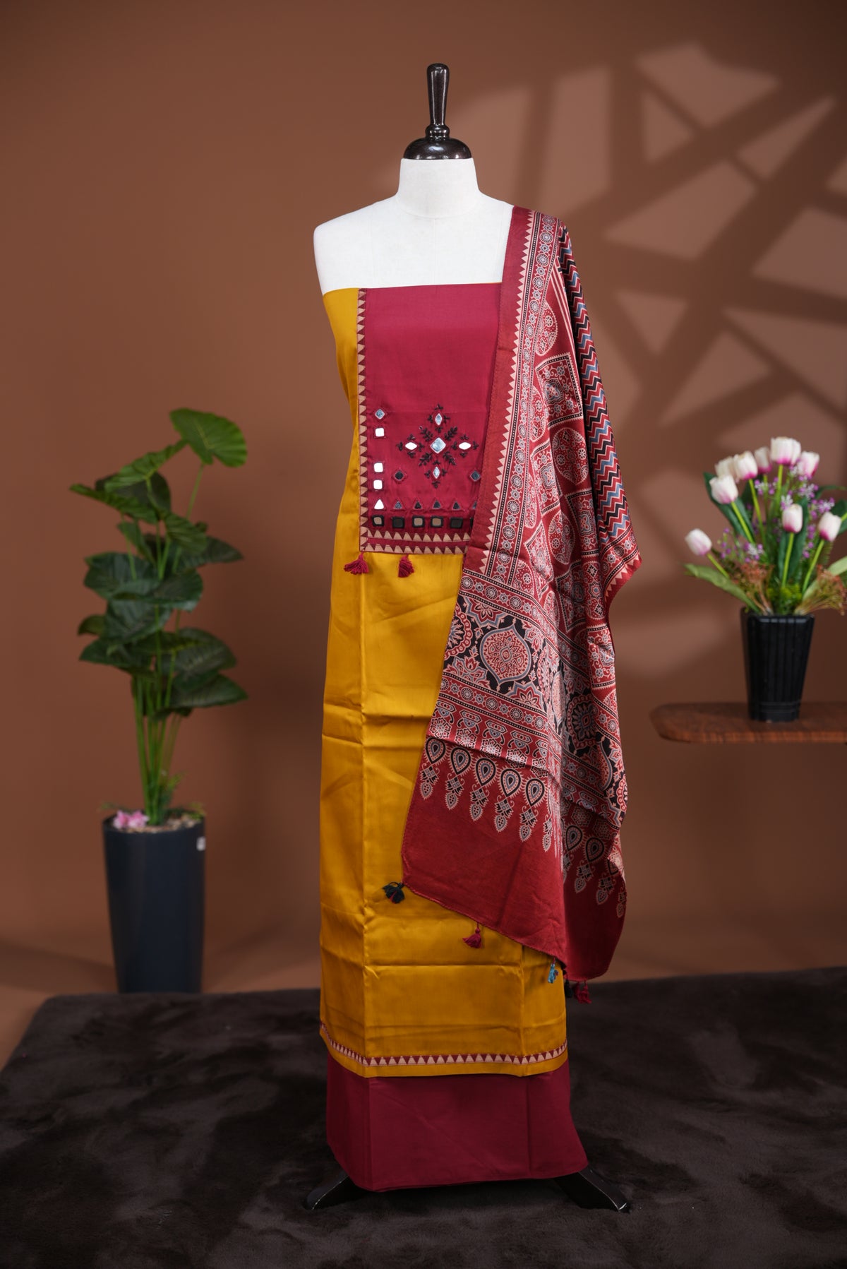 Mustard Yellow colour Jam Satin salwar material, Plain body with mirror & thread work on neck portion, matching bottom and Dupatta with ajrak print.