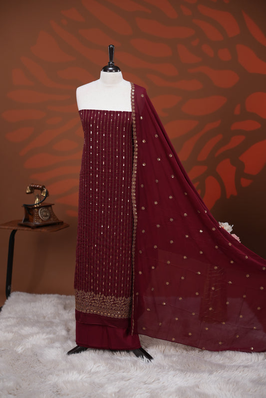 Maroon colour Georgette salwar material featuring Sequins Stripes on body, paired with matching dupatta on scallop border & Santoon bottom.