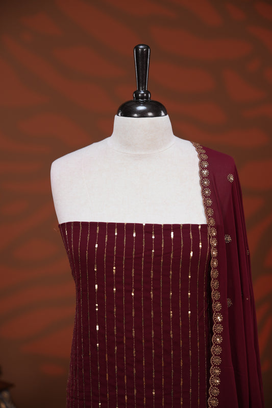 Maroon colour Georgette salwar material featuring Sequins Stripes on body, paired with matching dupatta on scallop border & Santoon bottom.