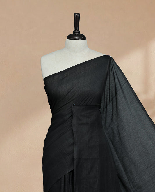 Black Colour Mul Cotton saree featuring Elegant plain body, Comes with no border, finished with stylish tassels.