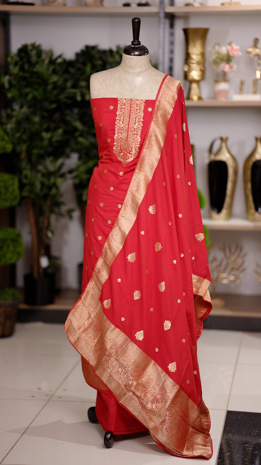 Red colour semi silk salwar suit featuring heavy golden embroidery thread work on the top, paired with a plain bottom & Comes with a dupatta highlighted with golden work along the side border.