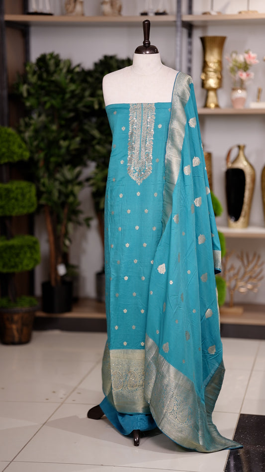Blue colour semi silk salwar suit featuring heavy golden embroidery thread work on the top, paired with a plain bottom & Comes with a dupatta highlighted with golden work along the side border.