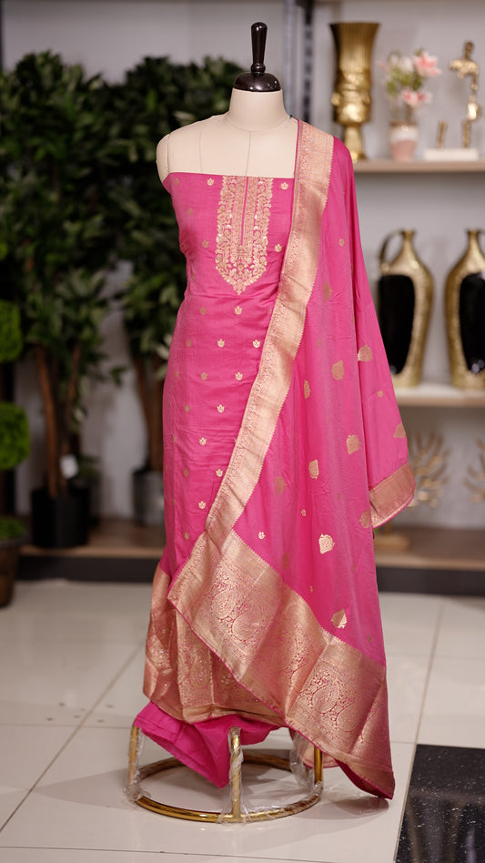 Magenta colour semi silk salwar suit featuring heavy golden embroidery thread work on the top, paired with a plain bottom & Comes with a dupatta highlighted with golden work along the side border.