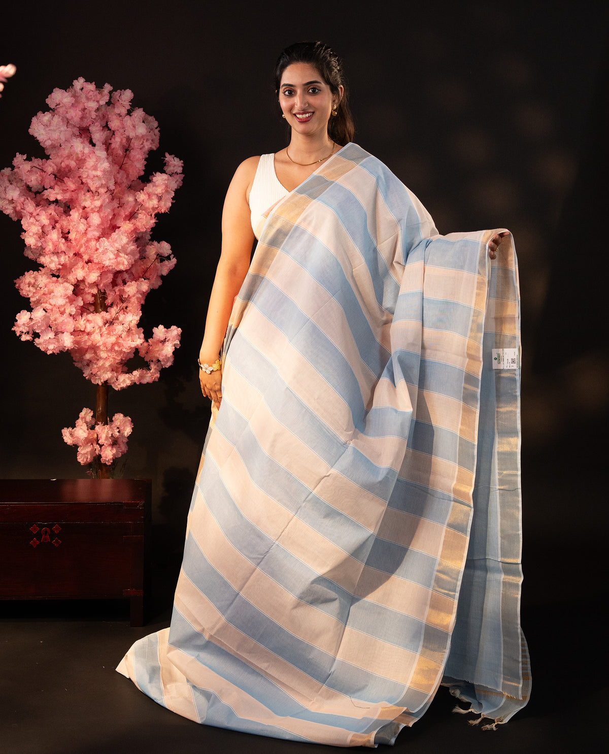 Blue & Beige dual colour Poly cotton saree featuring Stripped design body, complemented by kasavu border and pallu Finished with elegant tassels, comes with matching blouse piece.