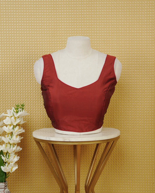 Dark red colour Sleeveless Blouse Featuring A Stylish Sweetheart Neck, Smooth Finish, And A Comfortable Tailored Fit.