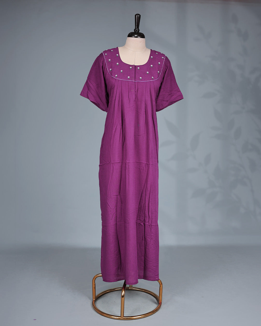 Dark Plum solid nighty featuring a floral embroidered yoke with contrast piping, a round neckline & short sleeves and a relaxed full-length for all-day comfort and timeless style.