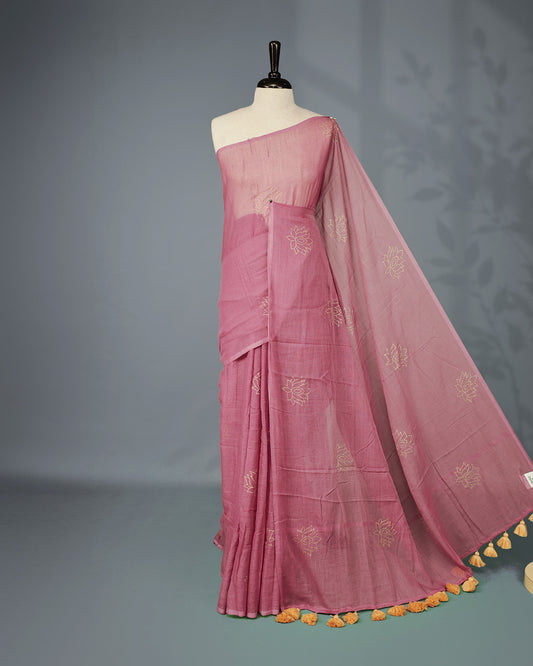 Onion colour pure mul cotton saree featuring Minimal Lotus Print on body, Clean Borderless design, elegant tassels.