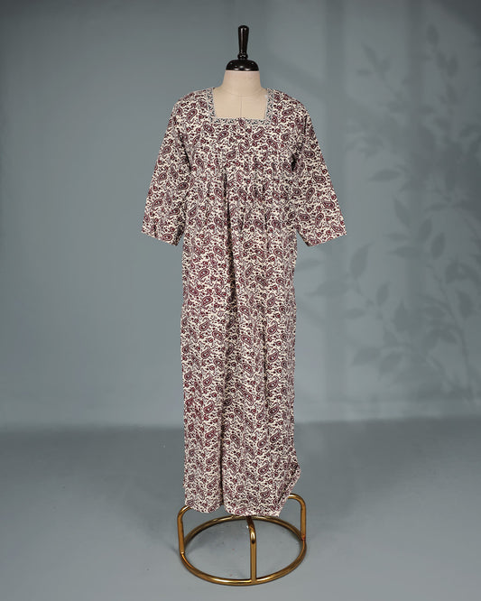 Cream and maroon paisley printed nighty with a classic square neckline, three-quarter sleeves, elegant border detailing and a relaxed full-length silhouette for everyday comfort and timeless style.
