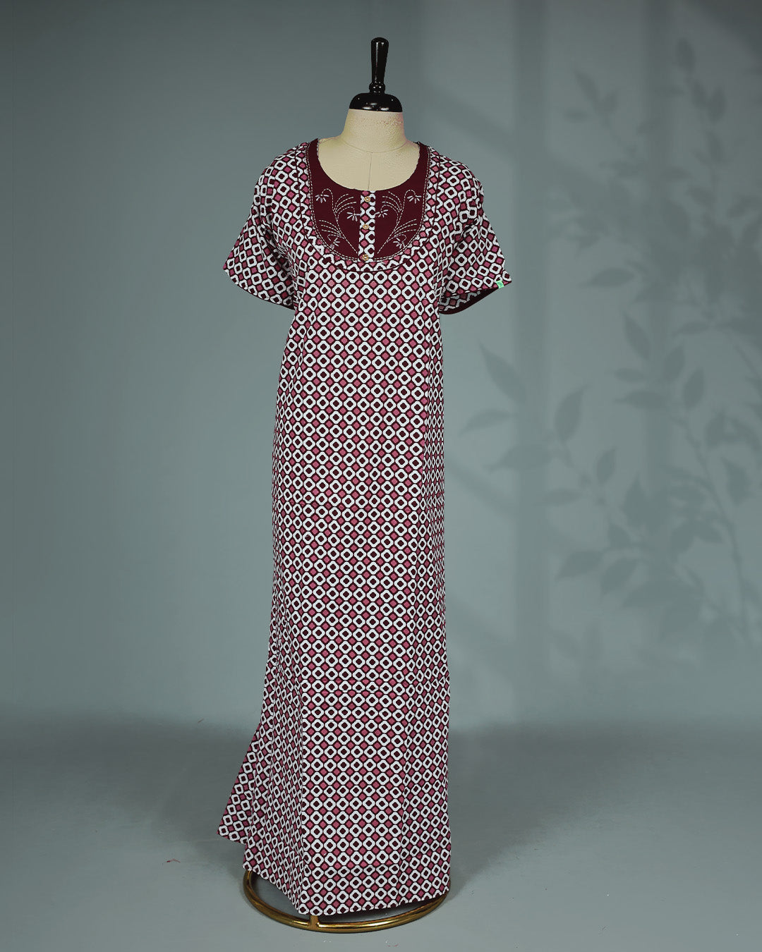 Maroon & White printed nighty featuring an elegant round neckline with embroidered yoke and decorative button detailing, short flutter sleeves and a relaxed full-length fit