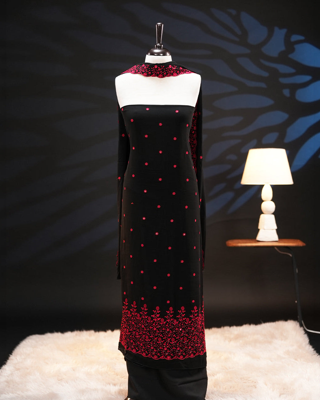 Black Colour georgette salwar material featuring delicate floral threadwork on the body and intricate threadwork with sequin detailing on bottom, paired with a scalloped border dupatta and Shantoon bottom