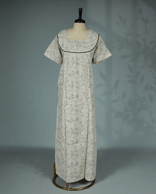 Beige & Black colour floral kodi printed nighty featuring a graceful round yoke with delicate black lace trim, soft front pleats, short sleeves and a relaxed full-length  for breathable comfort and timeless everyday style.