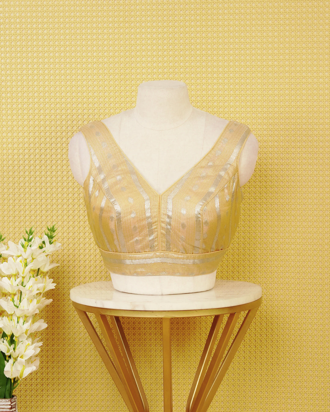 Pale Yellow colour Sleeveless Blouse Featuring A Stylish V-Neck, Elegant Woven Zari Stripes With Butta Motifs, And A Comfortable Tailored Fit.