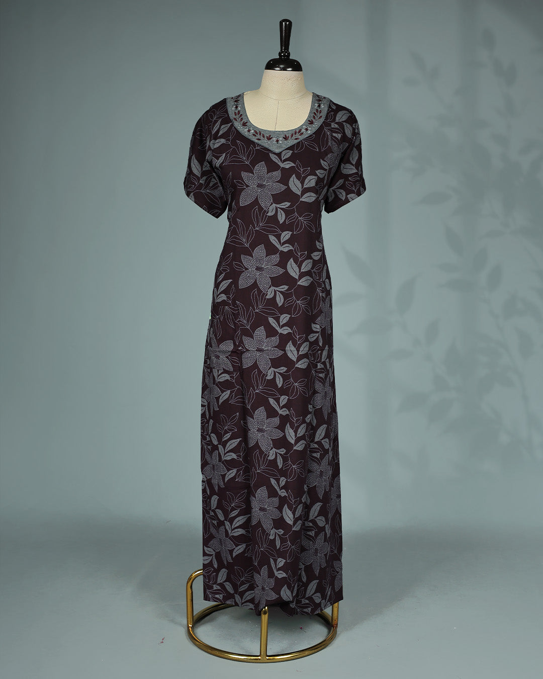 Dark brown floral kodi printed nighty featuring a round embroidered neckline with contrast grey yoke detailing, short sleeves and a comfortable ankle-length fit.