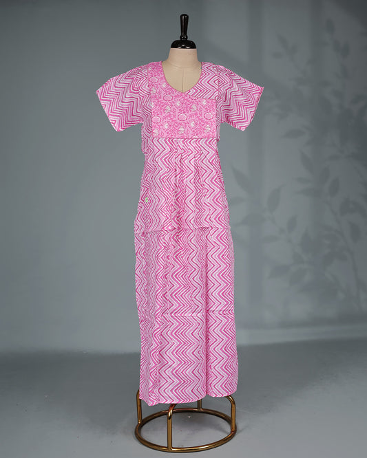 Pink colour nighty featuring a zigzag print with a floral yoke, a round neckline, short sleeves and an ankle-length fit.