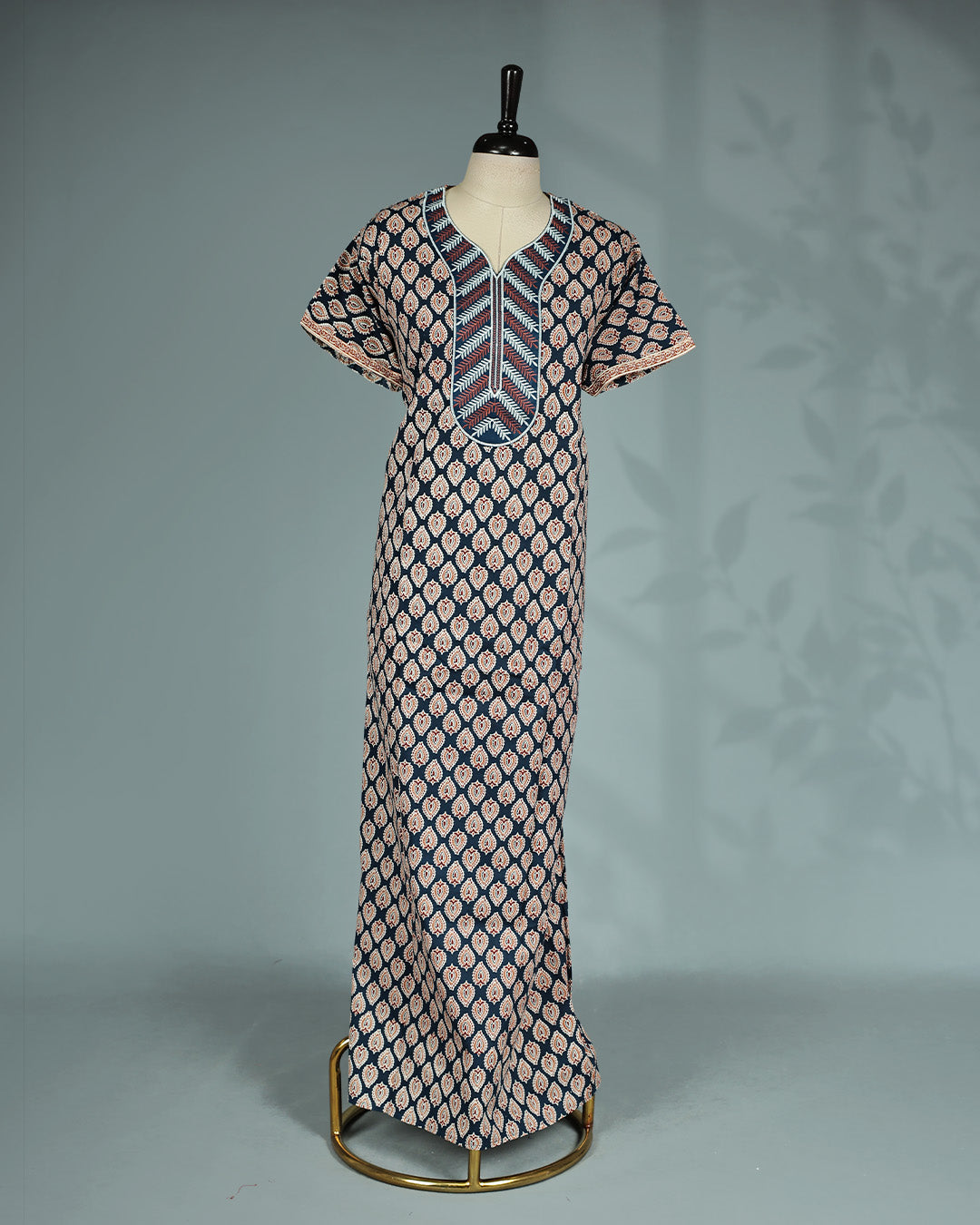 Navy blue and rust paisley printed nighty with a split V-neckline, short sleeves, a thread worked yoke with intricate leaf motifs, and a relaxed full-length for everyday comfort and effortless style.