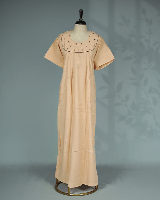 Peach solid nighty with a classic square neckline, short sleeves, delicate floral embroidery on the yoke, subtle contrast piping, and a relaxed full-length for everyday comfort and elegant simplicity.
