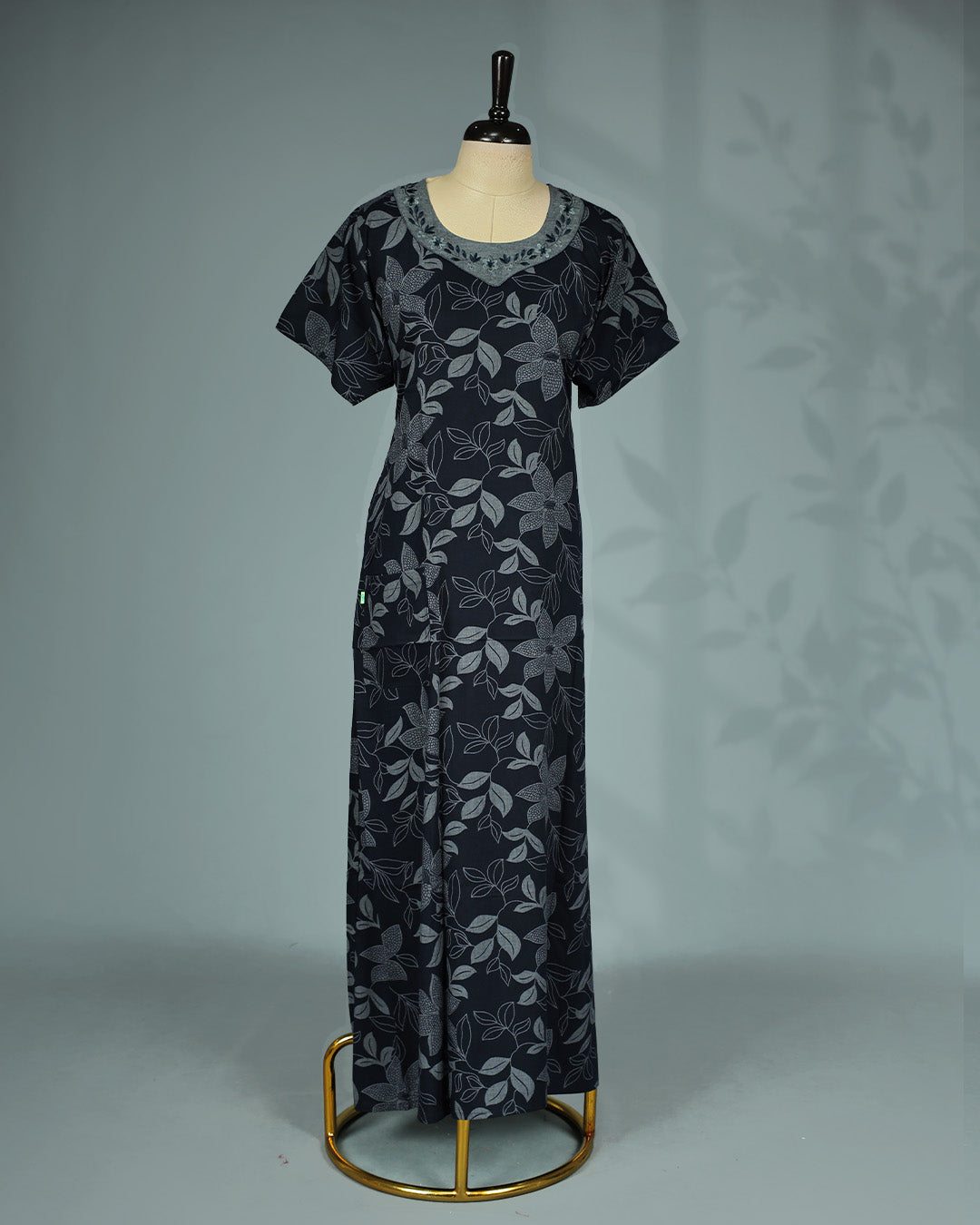 Elegant black floral kodi printed nighty featuring a round neckline with embroidered contrast yoke ,short sleeves and a relaxed full-length for effortless comfort and graceful everyday wear.