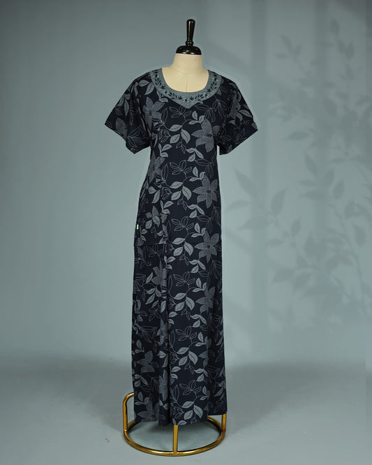 Elegant black floral kodi printed nighty featuring a round neckline with embroidered contrast yoke ,short sleeves and a relaxed full-length for effortless comfort and graceful everyday wear.