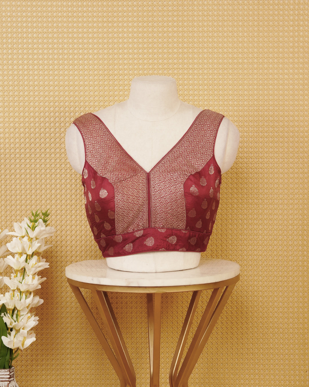 Chocolate colour Sleeveless Blouse Featuring A Stylish V-Neck, Elegant Woven Pattern With Gold Butta Motifs, And A Comfortable Tailored Fit.