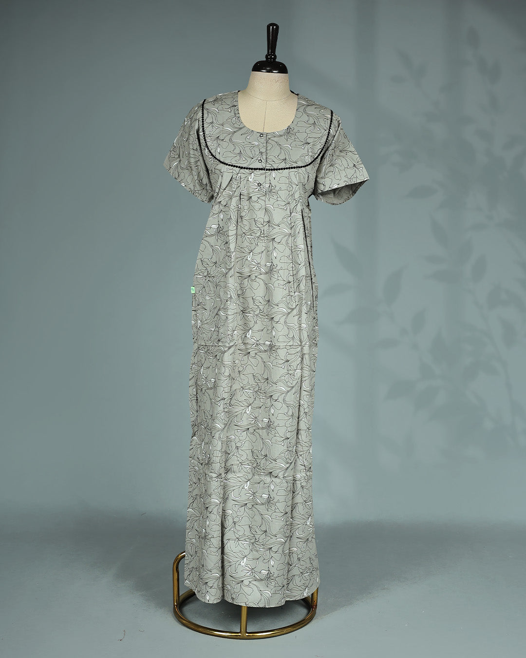 Light Grey colour nighty featuring floral prints on body, an openable button-front round neckline with black lace trim, short sleeves and an ankle-length fit.