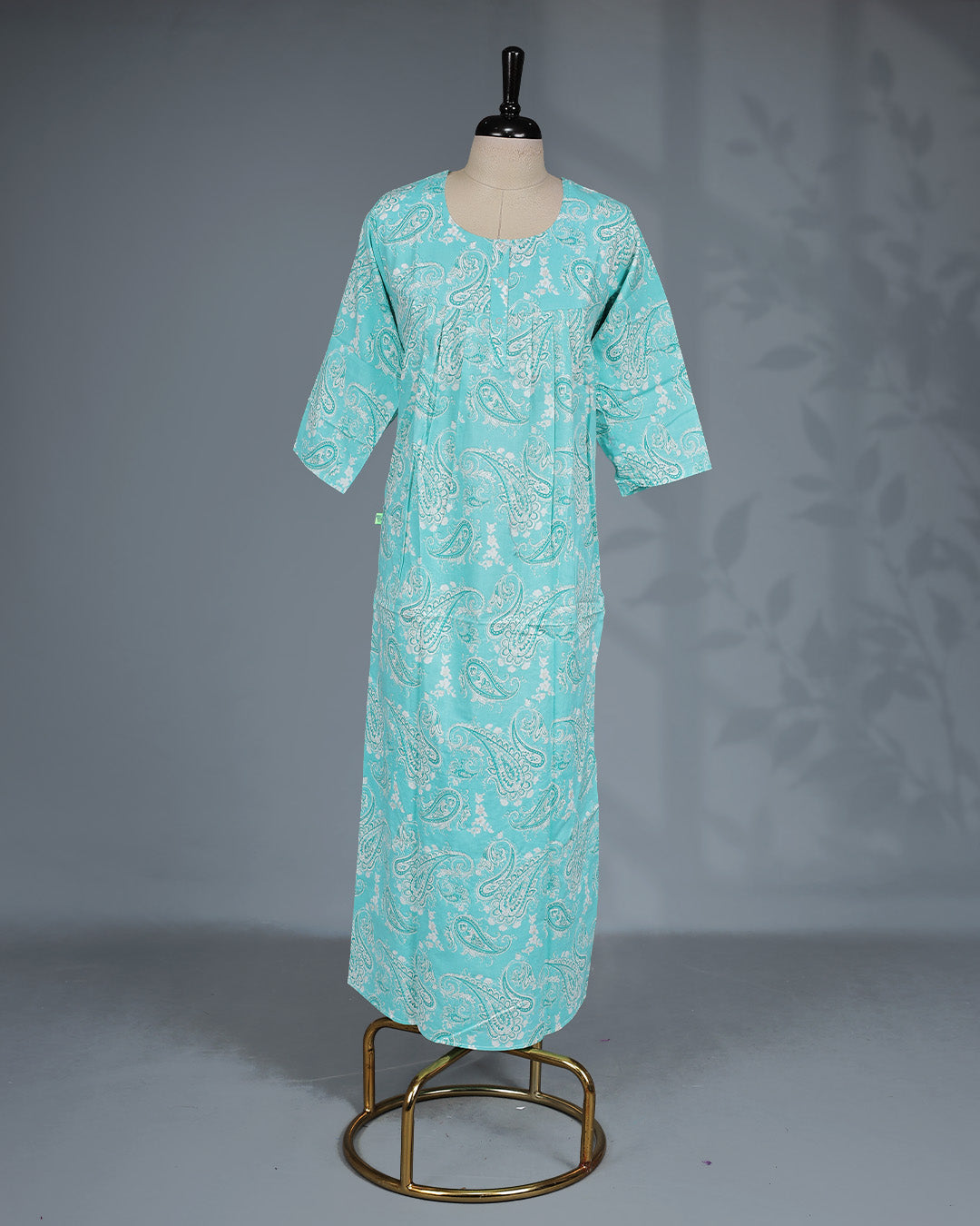 Aqua blue colour printed nighty featuring a classic round neckline With Openable Button, three-quarter sleeves and a relaxed full-length silhouette for breathable comfort and effortless everyday wear.