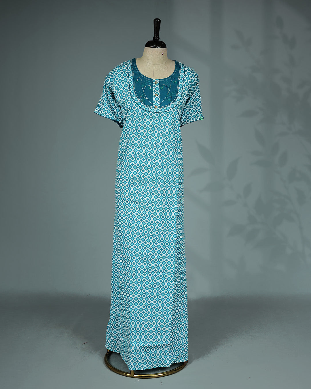 Light Blue Colour printed nighty featuring a stylish contrast embroidered yoke with decorative wooden buttons, a classic round neckline, short sleeves and a relaxed full-length fit for breathable comfort and everyday elegance.