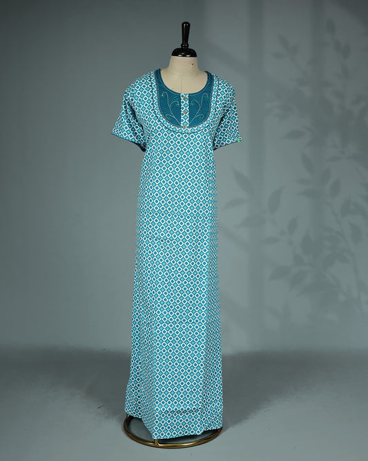 Light Blue Colour printed nighty featuring a stylish contrast embroidered yoke with decorative wooden buttons, a classic round neckline, short sleeves and a relaxed full-length fit for breathable comfort and everyday elegance.