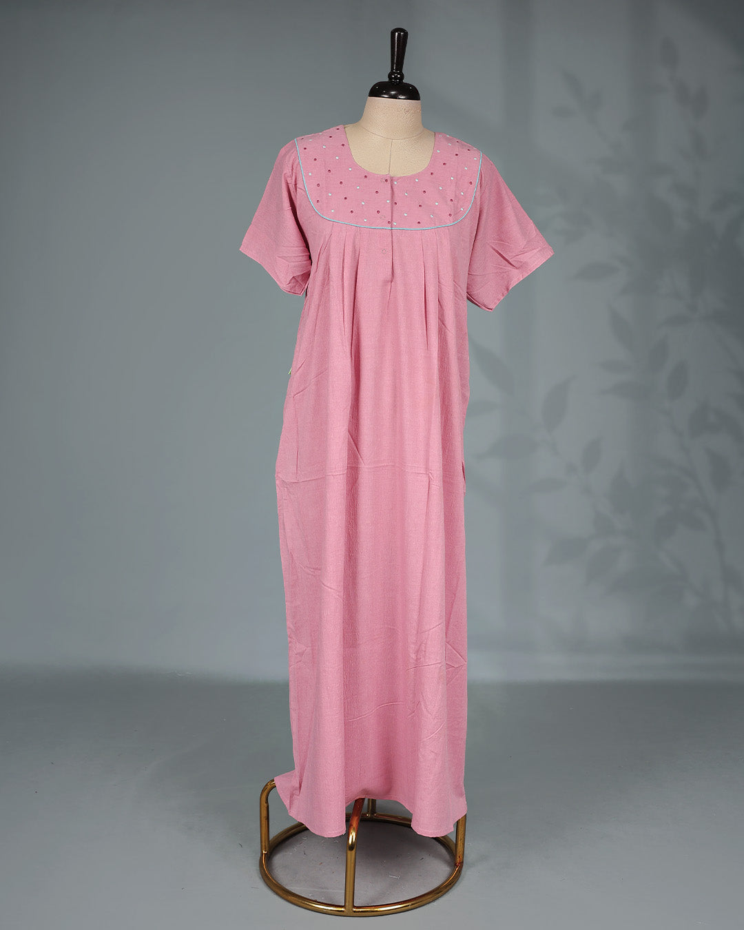 Baby Pink colour nighty featuring a Thread work on yoke, an U shaped openable button-front design, short sleeve and an ankle-length fit.