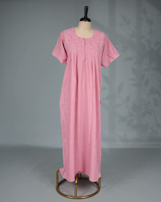 Baby Pink colour nighty featuring a Thread work on yoke, an U shaped openable button-front design, short sleeve and an ankle-length fit.