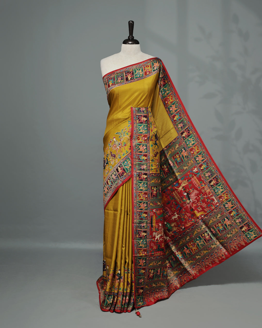 Mustard Colour Pashmina Saree featuring Plain body, complemented by Contrast Red colour with Man With Horse pattern & gold zari on border and Pallu, comes with matching blouse piece.