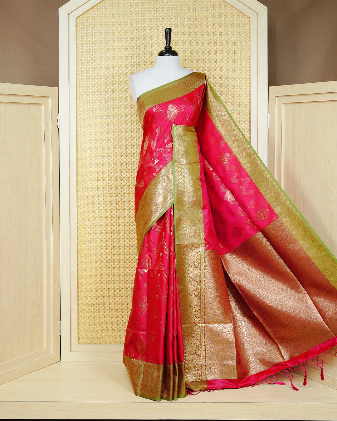 Pink Mulberry silk saree featuring gold floral zari patterns on body, paired with contrast light green colour with traditional border, comes with matching blouse piece.