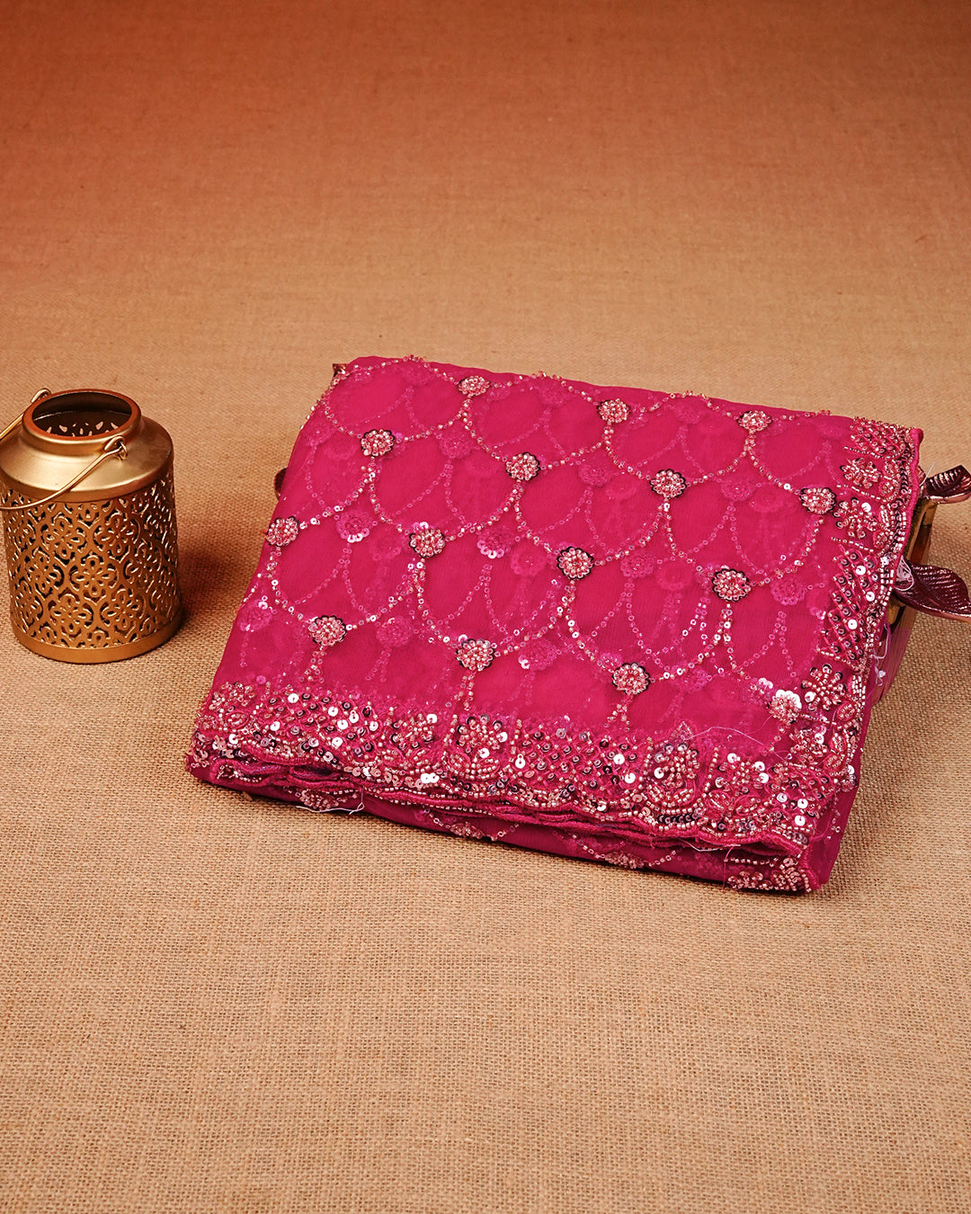 Rani pink colour Net Designer saree featuring Beats & Sequins geometric Pattern on body & worked border, comes with matching blouse piece.