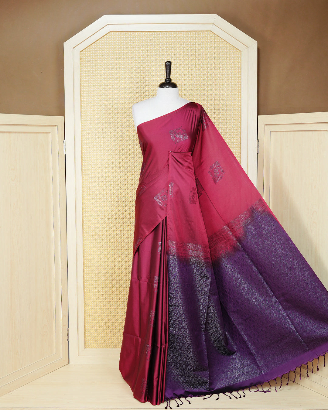 Maroon colour soft silk saree featuring antique zari motifs on body with contrast dark purple colour pallu & paired with matching blouse piece.
