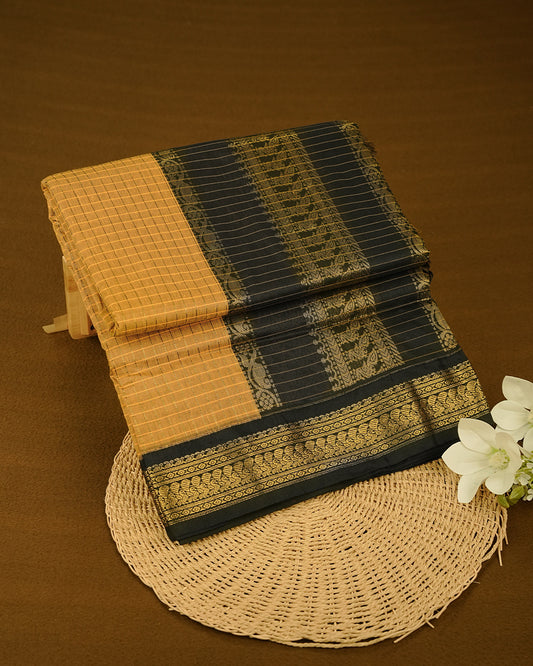 Mustard colour kalyani cotton saree featuring gold zari check pattern on body, complemented by Black colour with Antique zari border, paired with matching blouse piece