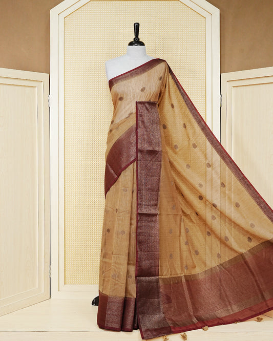 Sandal colour semi linen saree thread motifs on body, contrast maroon colour gold zari border, rich pallu comes with matching blouse piece