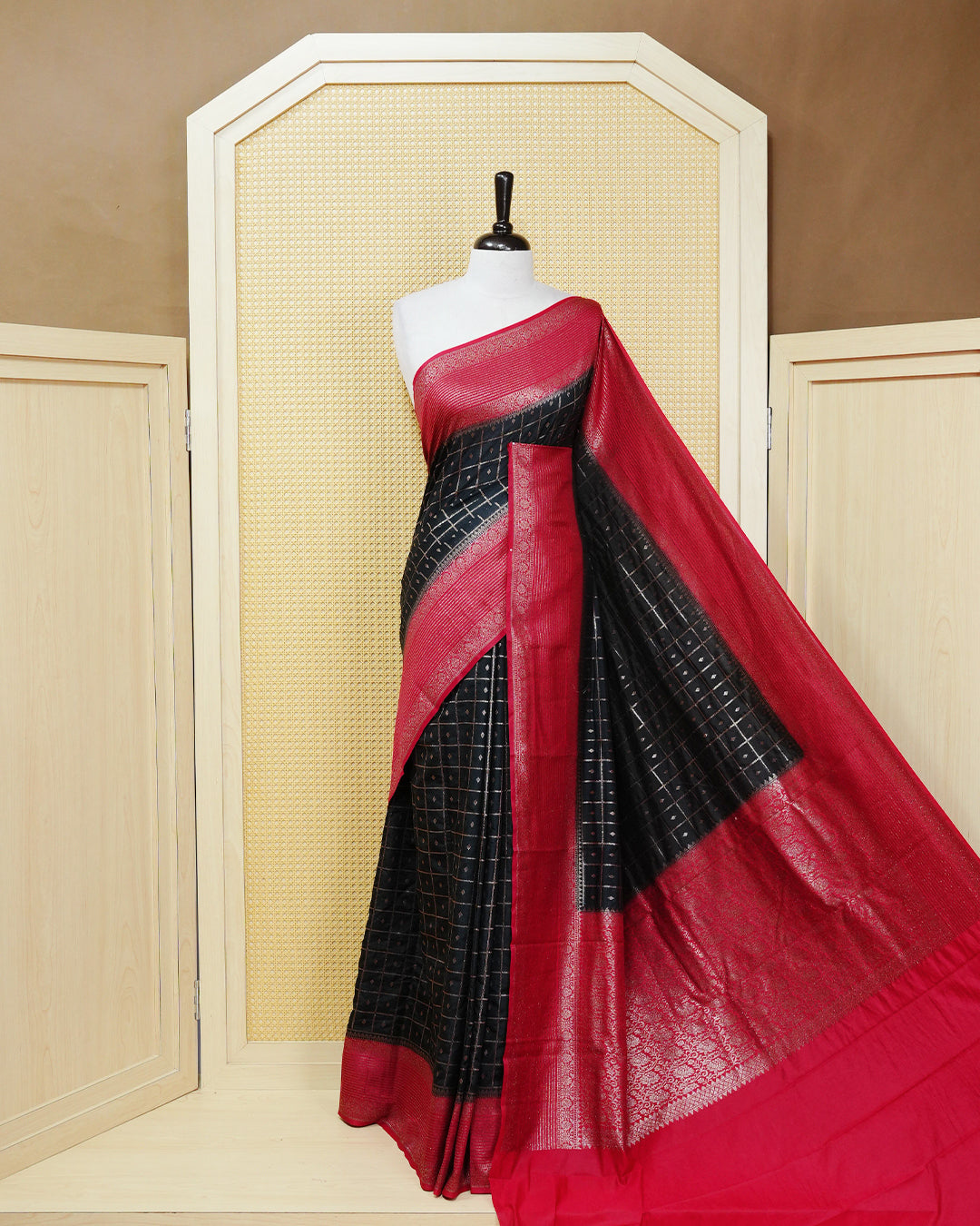 Black Colour Semi georgette Saree having zari check with buttas pattern on body, contrast red colour floral designed border, Rich Pallu comes with Matching Blouse piece.