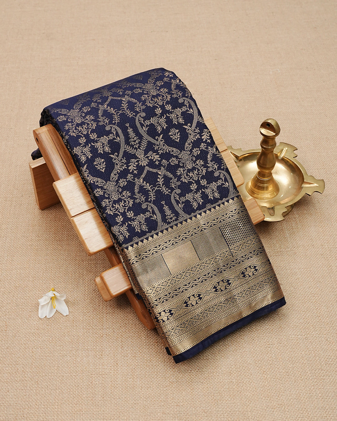 Navy Blue colour semi wedding saree featuring  gold zari Floral kodi  Pattern on body, contrast Self colour with traditional border, paired with matching blouse piece.