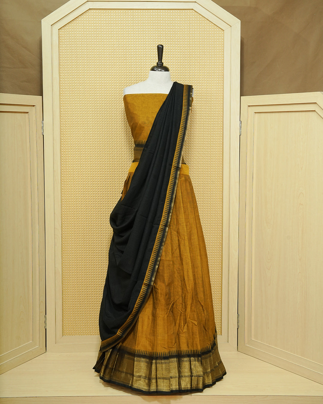 Mustard Colour chettinad cotton Semi stitched dhavani set featuring Contrast Black with Gold zari border skirt, comes with Matching blouse piece & dupatta.