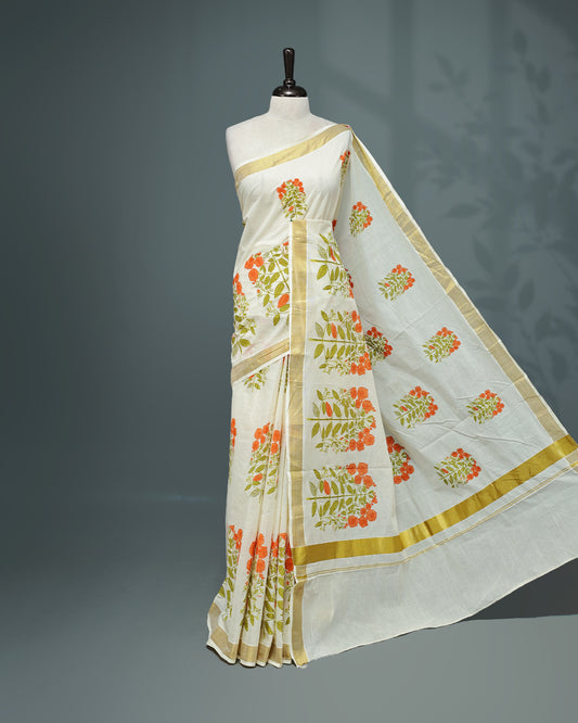Cream colour Cotton kerala saree featuring Orange colour floral Print on the body, complemented by a gold zari Border, paired with a matching blouse piece.