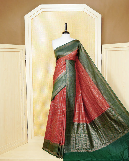 Burnt orange Colour Semi georgette Saree having zari check with buttas pattern on body, contrast dark green colour floral designed border, Rich Pallu comes with Matching Blouse piece.